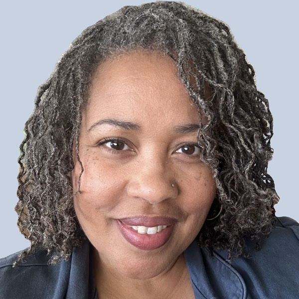 Caryn Saunders is a Black woman wearing a blue top