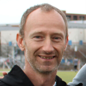 Frank Demarco is a white man outside at a soccer game