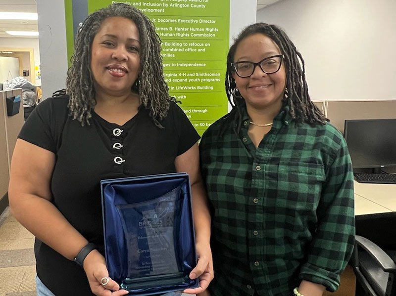 Volunteer Caryn Saunders stands with Youth Development Manager CeSha Whitfield