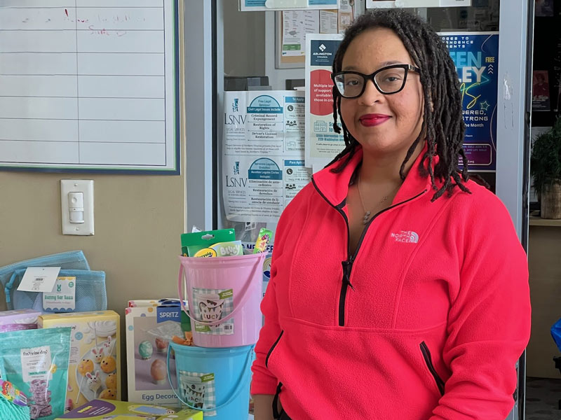 Youth Development Manager CeSha Whitfield distributing books and STEM projects to support community youth in reading and learning.