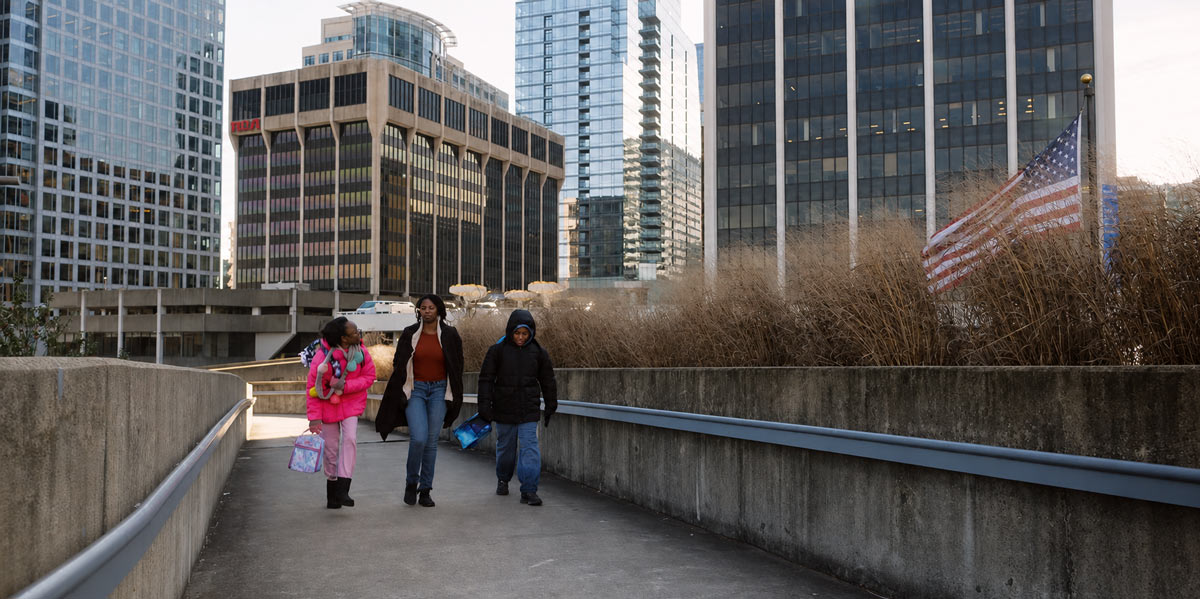 Family walking on a path in the city