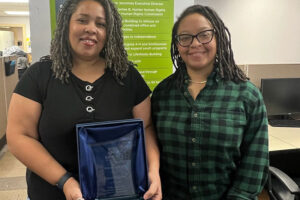 Volunteer Caryn Saunders stands with Youth Development Manager CeSha Whitfield